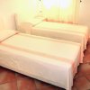 Due letti singoli con coperte beige.